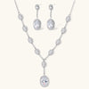 Elegant white gold plated jewelry set with oval cubic zirconia stones in halo settings, featuring Y-necklace and drop earrings.