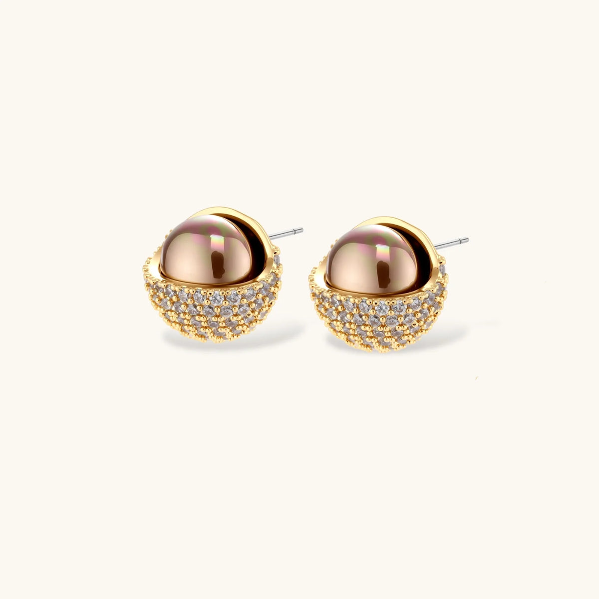 Elegant spherical pendant necklace and earrings set featuring crystal-pavé bottom half in gold or silver finish on white background.