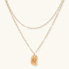 Layered paperclip chain necklace with organic flowing pendant made from eco-zinc alloy in warm gold finish