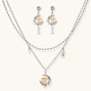Delicate eco-brass jewelry set featuring gold star and silver moon crescents with clear zirconia crystal drops on cream background
