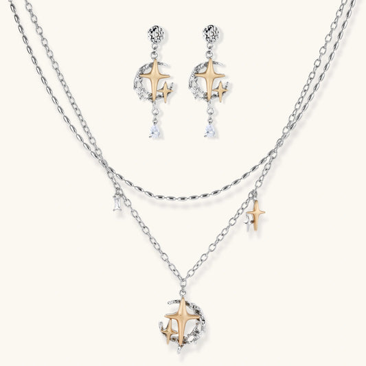 Delicate eco-brass jewelry set featuring gold star and silver moon crescents with clear zirconia crystal drops on cream background