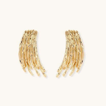 Flowing fringe earrings with cascading curved metal elements in gold tone, showing dimensional movement and sculptural design.