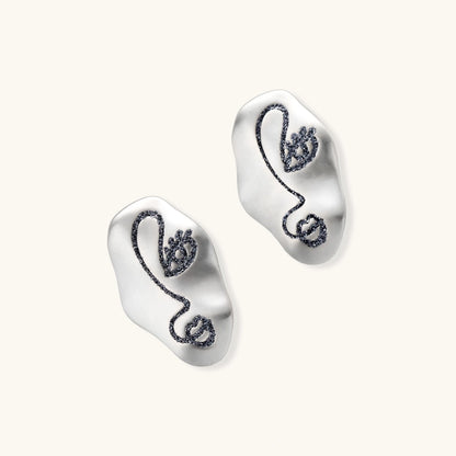 Artistic ear-shaped earrings with minimalist face line art on clear eco-zinc alloy base with sterling silver posts.
