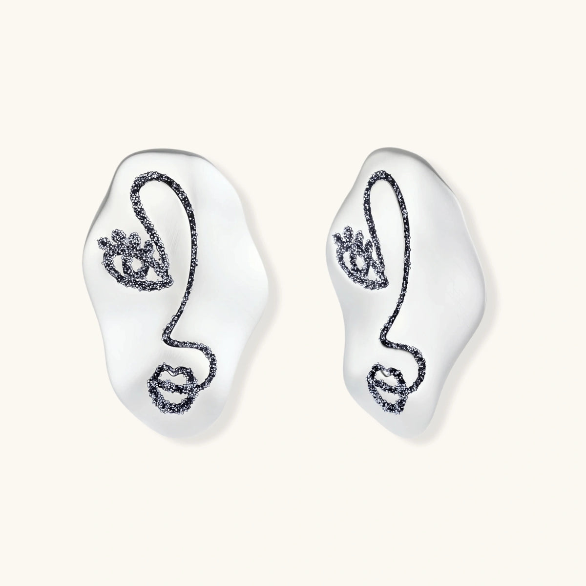 Artistic ear-shaped earrings with minimalist face line art on clear eco-zinc alloy base with sterling silver posts.