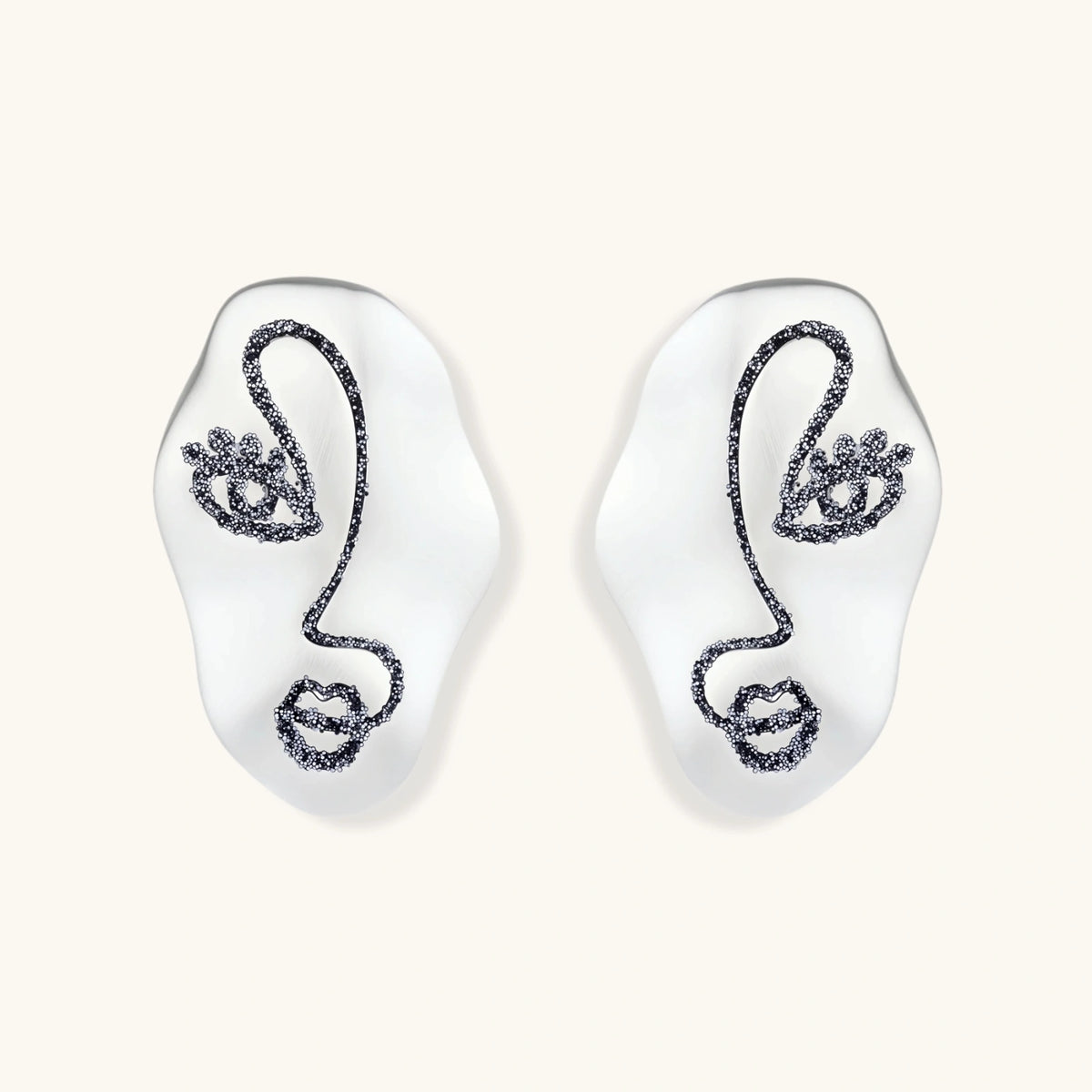 Artistic ear-shaped earrings with minimalist face line art on clear eco-zinc alloy base with sterling silver posts.