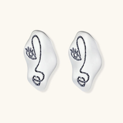 Artistic ear-shaped earrings with minimalist face line art on clear eco-zinc alloy base with sterling silver posts.