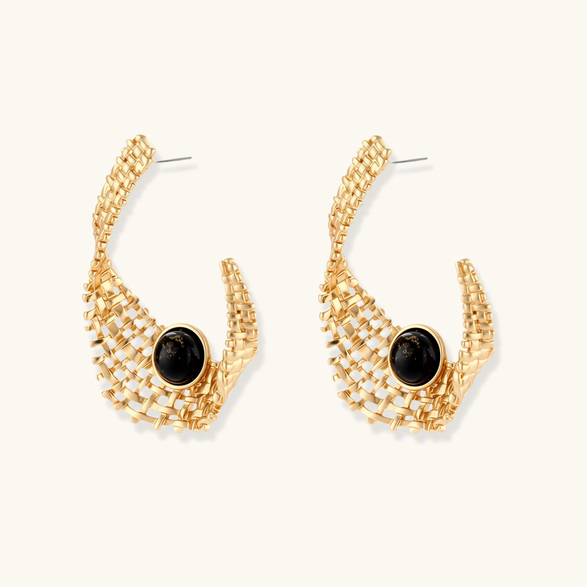 Gold-tone sculptural earrings with interwoven mesh design and black resin stone accents on white background.