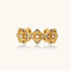 Gold-plated adjustable ring with multiple flower motifs, each featuring a central pearl and cubic zirconia stones