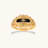 Ornate 18K gold-plated ring with black enamel center featuring star motif and decorative baroque-style edges on white background.