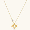 18K gold-plated 925 silver necklace with open four-petal flower pendant, CZ accents, bezel-set stone on chain, white background.