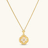 Gold-plated flower pendant necklace with brushed finish, open-work center, marquise CZ stones on wheat chain, S925 stamp.