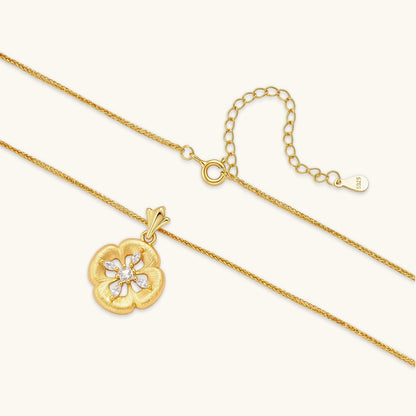 Gold-plated flower pendant necklace with brushed finish, open-work center, marquise CZ stones on wheat chain, S925 stamp.